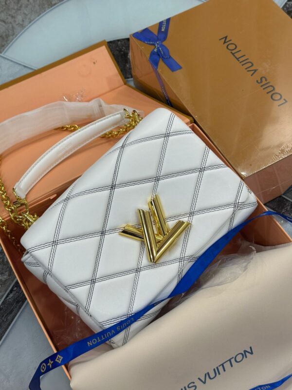 LOUISS VUITTONN GRAND TWISTER HANDBAG CUM SLING